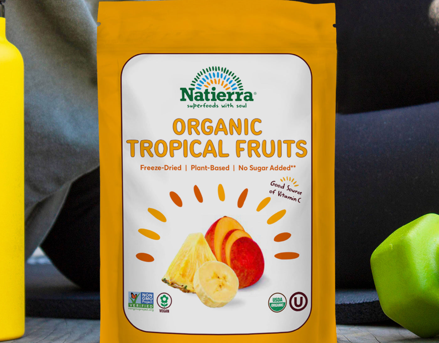 organic Tropical Fruit freeze-dried snack bag on the ground next to a person exercising