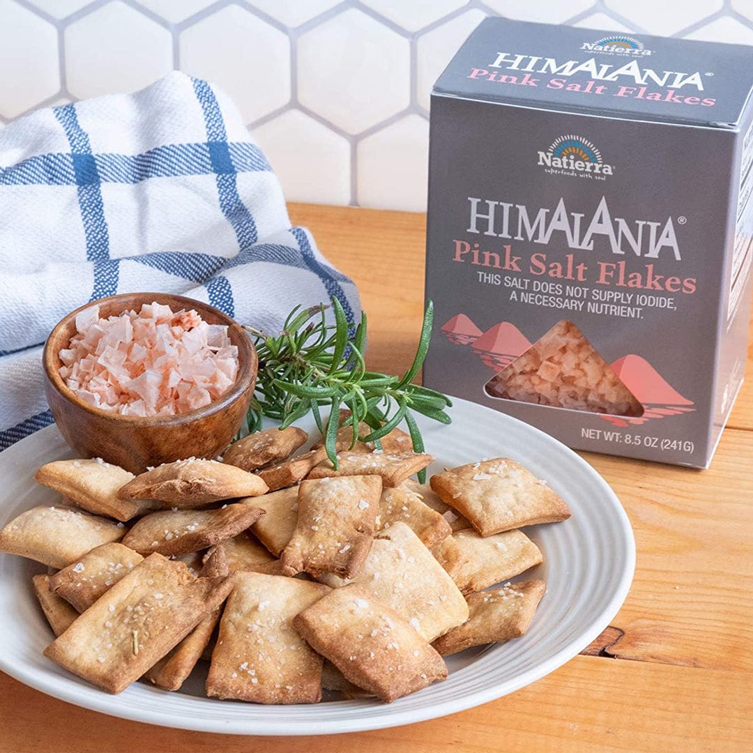 A plate of crackers and a box of Natierra Himalania Pink Salt Flakes