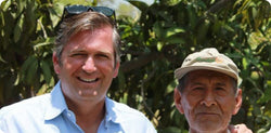 Photo of Thierry Ollivier with a local farmer in front of a tree