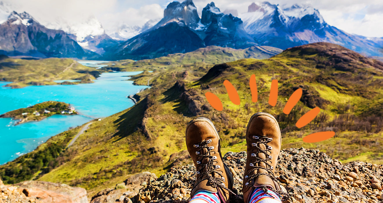 Hiker foots over looking a mountain ridge and lake scenery