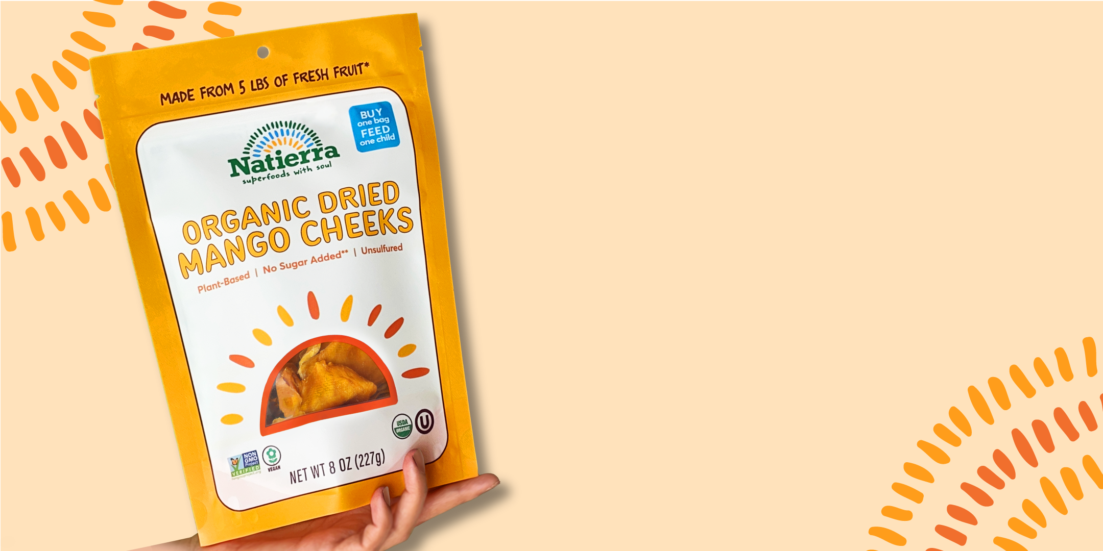 Hand holding bag of Dried Mango cheeks
