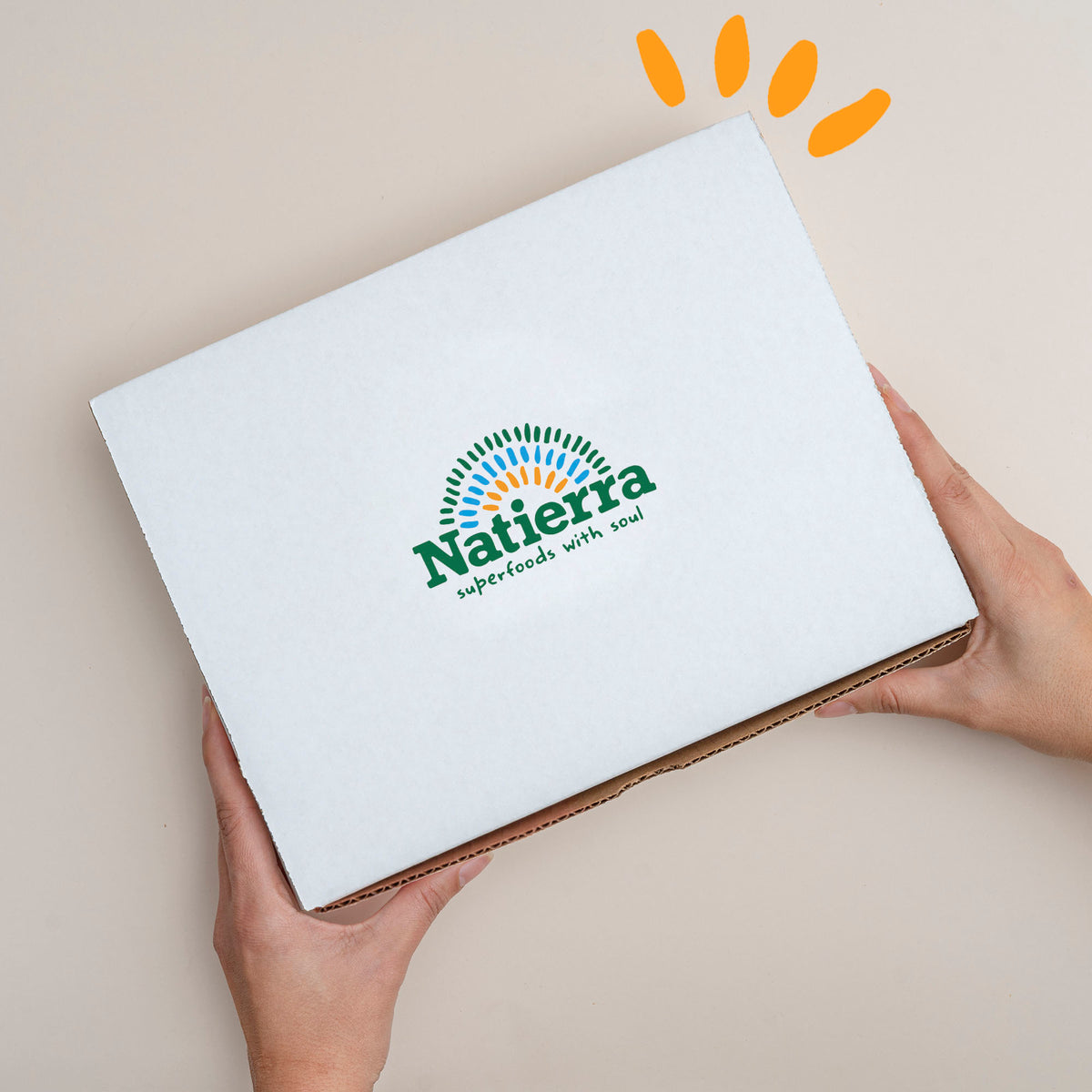 Natierra smoothie box held by 2 hands with colored beads on the top