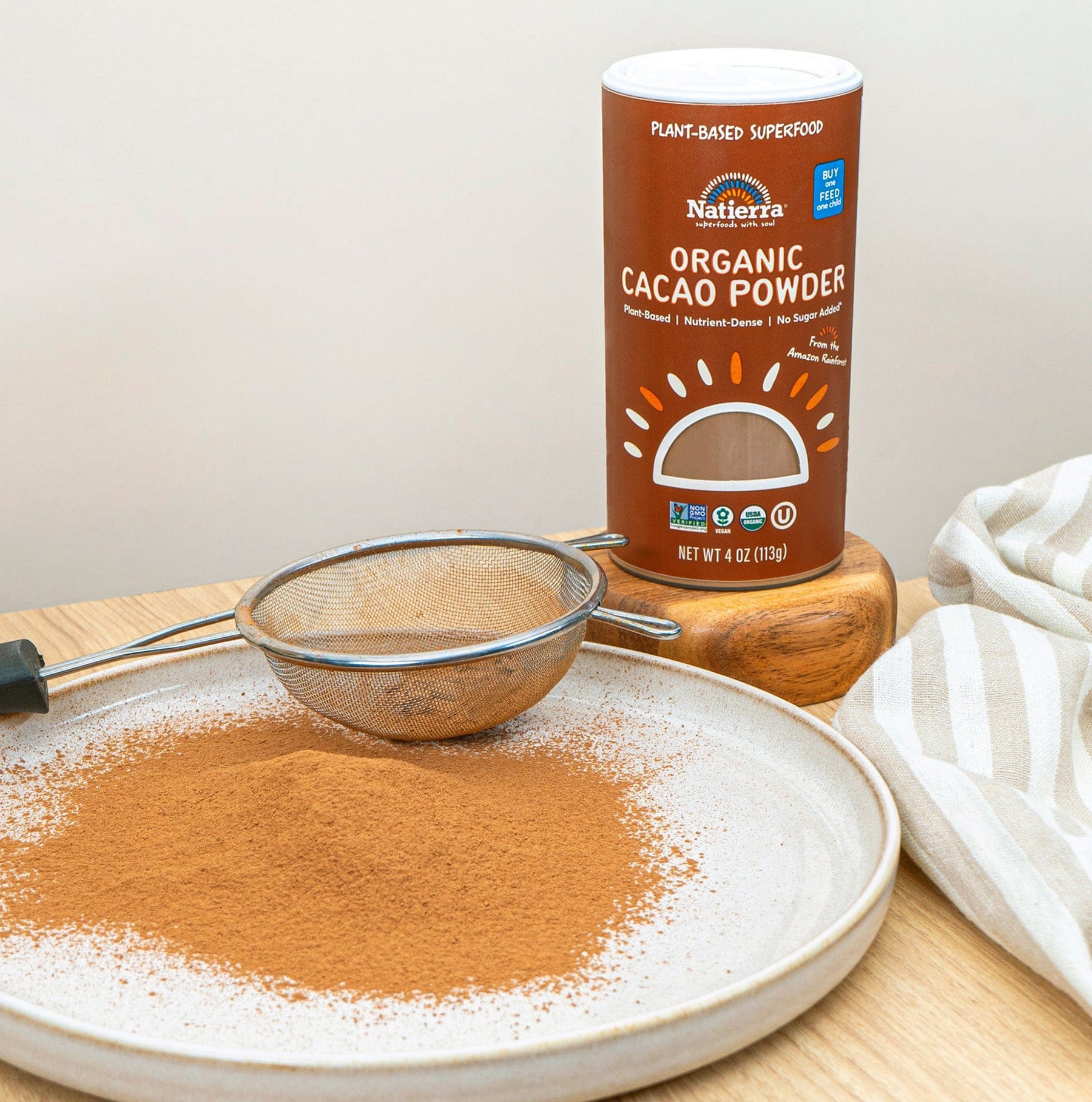 Natierra Organic Cacao Powder with powder on a plate with a small drainer.
