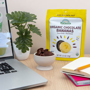  Natierra Organic Chocolate Covered Bananas on an office desk with office accessories  thumbnail