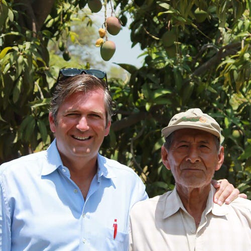 Thierry posing with farmer for a picture 