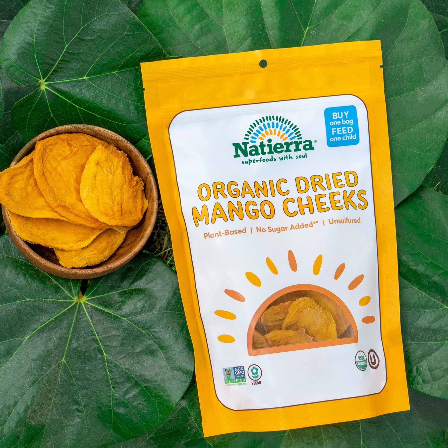 Natierra Organic Dried Mango Cheeks next to a small bowl with mango cheeks
